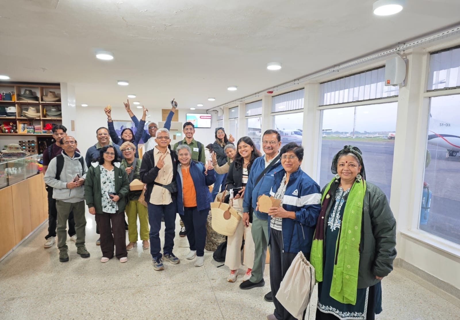 Happy tour group gathered at the airport terminal before flying out to the Masai Mara